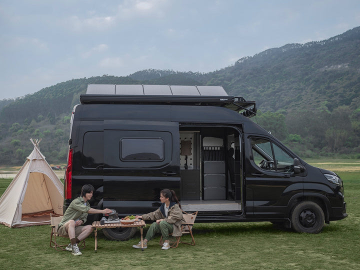 Black RV with EcoFlow power kit parked in nature, showcasing off-grid distribution solutions for tiny homes and mobile living.