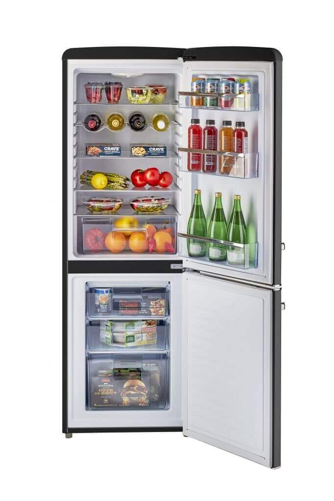 Unique 9 cu/ft retro AC bottom mount refrigerator with open door showing stocked shelves of food and beverages.