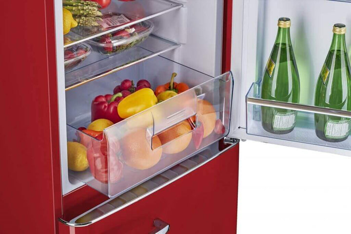 Retro red bottom mount refrigerator with fresh produce and beverages inside.