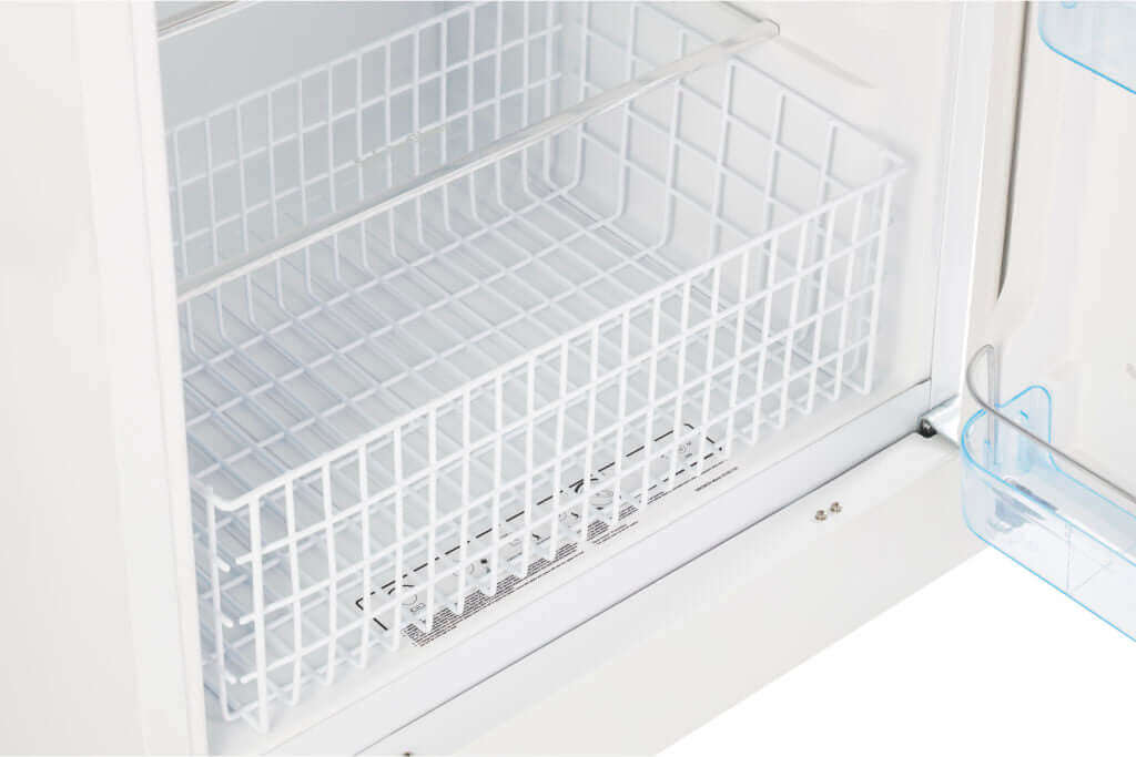 Interior of Unique 14 CU/FT Propane Refrigerator showing a removable adjustable wire basket for efficient storage.