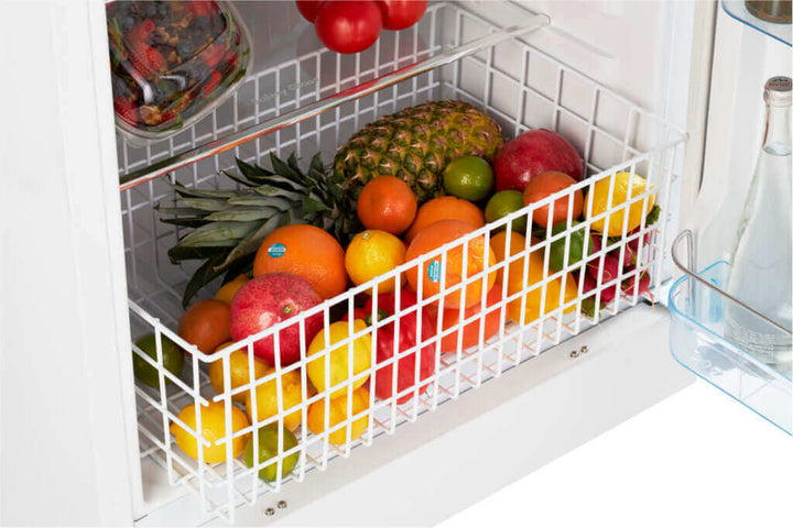 Propane fridge interior with fresh fruits in basket, showcasing ample storage space and modern design.