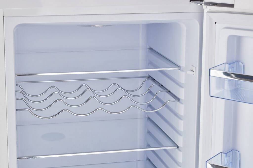 Open view of Unique 9 cu/ft Retro AC Bottom Mount Refrigerator interior with shelving.