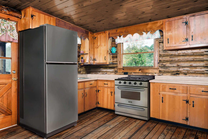 Rustic kitchen with 30" stainless steel propane range and matching off-grid refrigerator, featuring modern design and cast-iron grates.