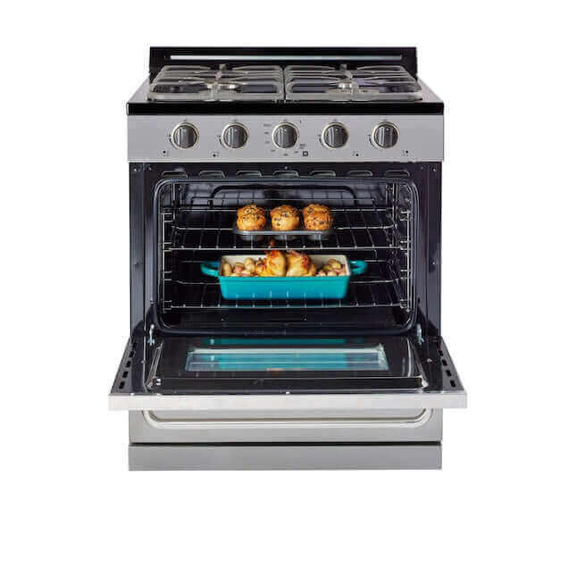 Stainless steel propane range with open oven showing baked goods, featuring cast iron grates and off-grid battery ignition.